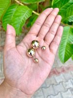 Big gold loop earrings at back - Image 2
